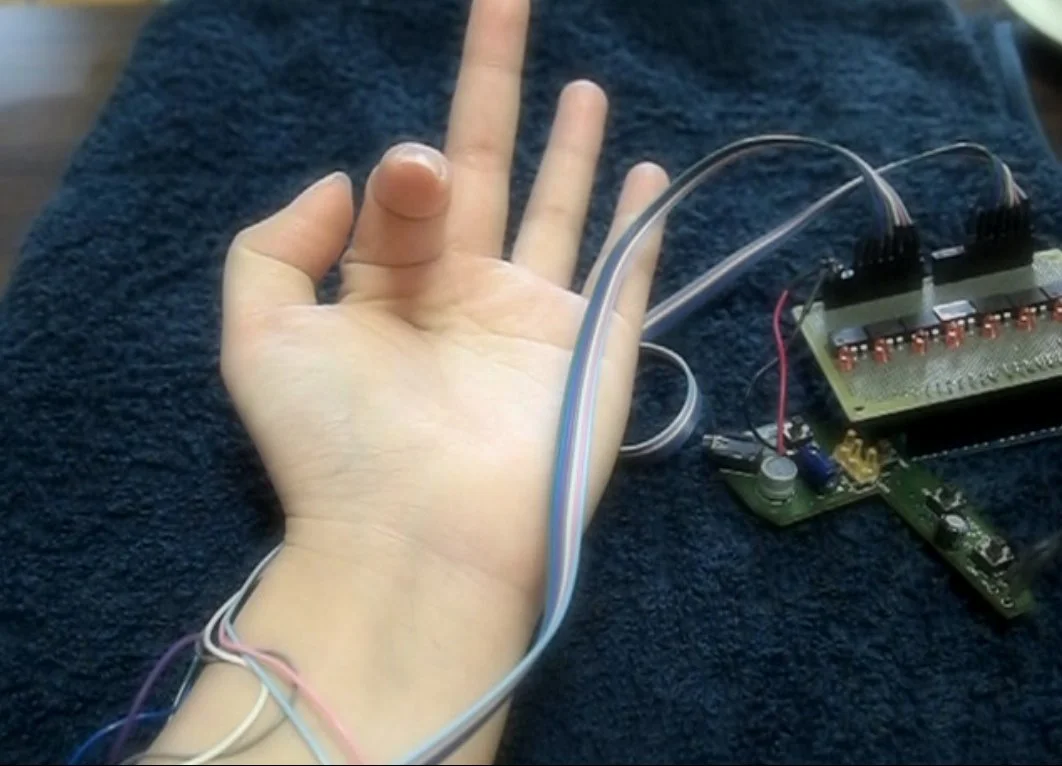 PossessedHand stimulates muscles in the forearm to move a wearer's finger (Photo: Emi Tamaki and Jun Rekimoto / University of Tokyo)