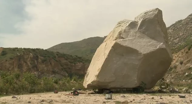 The centerpiece for Levitated Mass awaits its ride to the museum