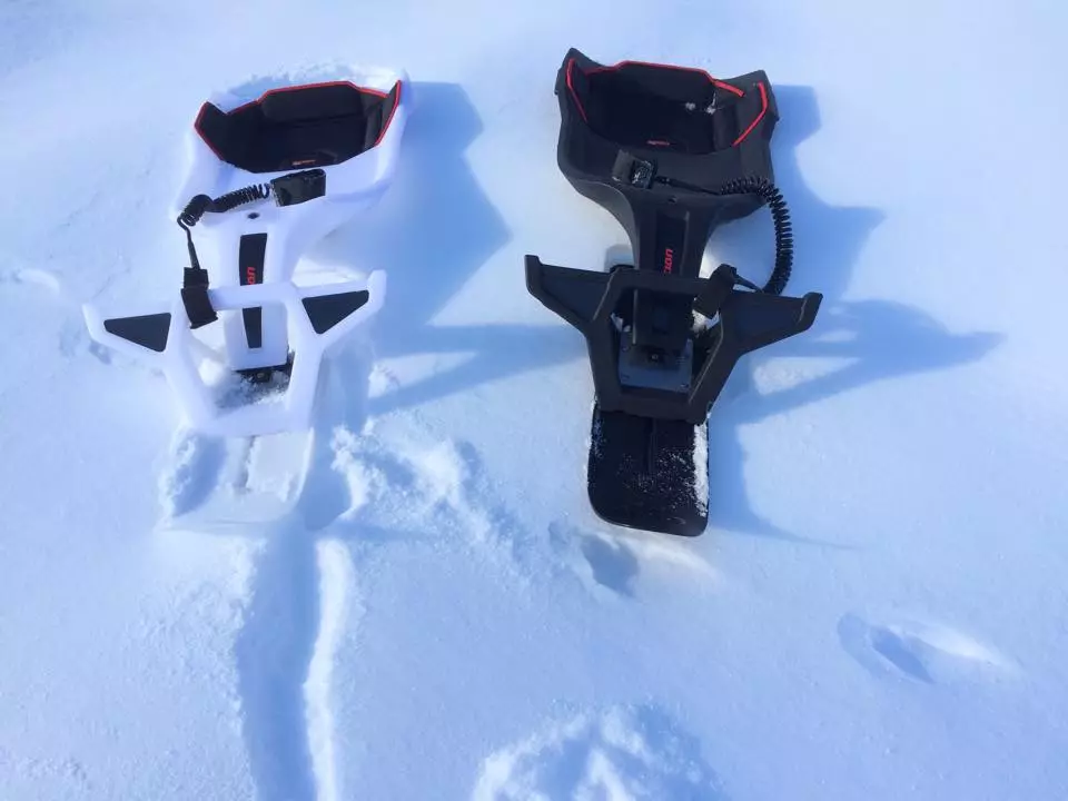 The Scion features a sleek, body-hugging monocoque shell, a front ski with foot pegs, and an arm connecting the two