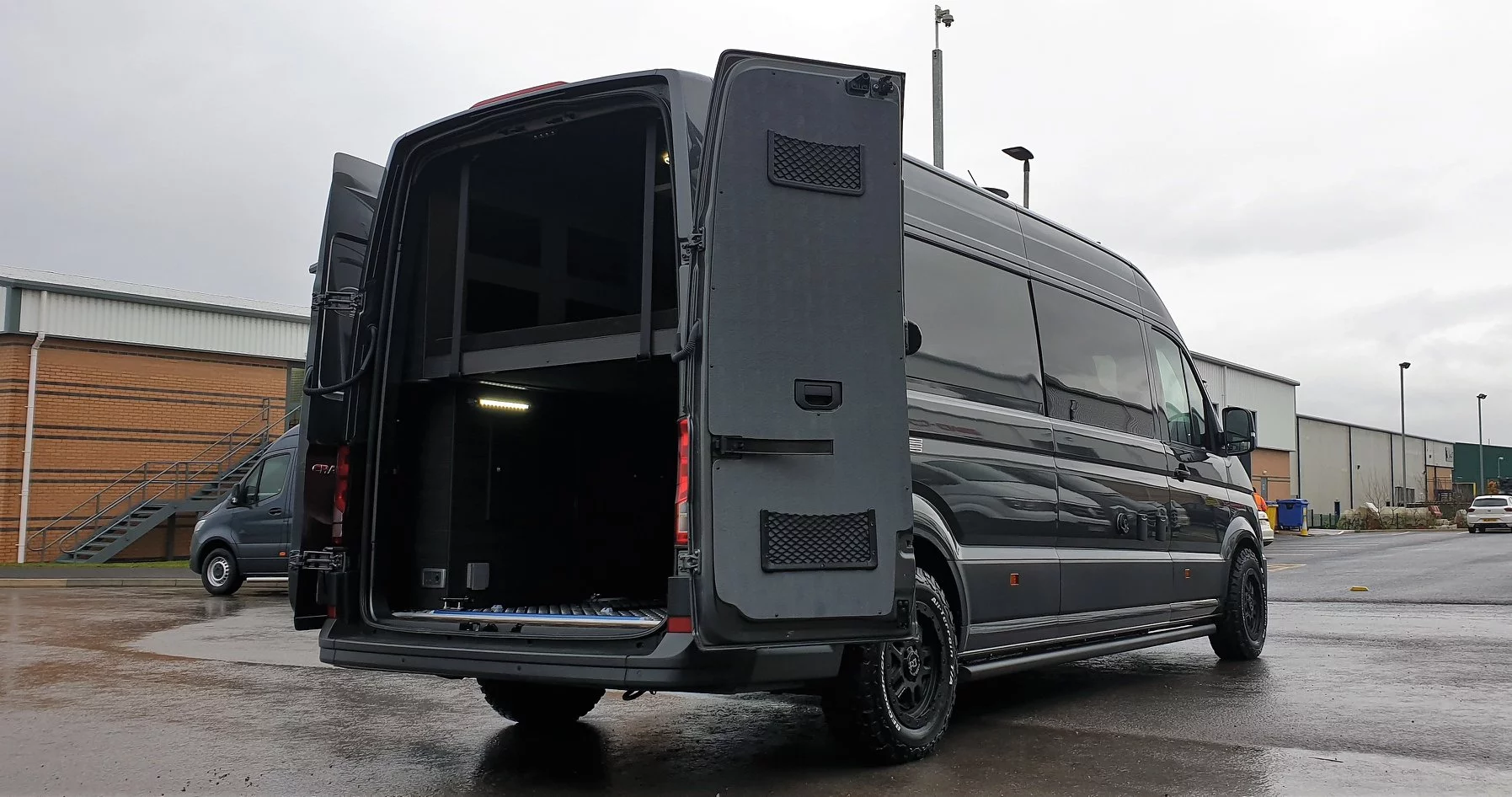 Pop open the rear doors and load cargo with the help of the lift-away bed