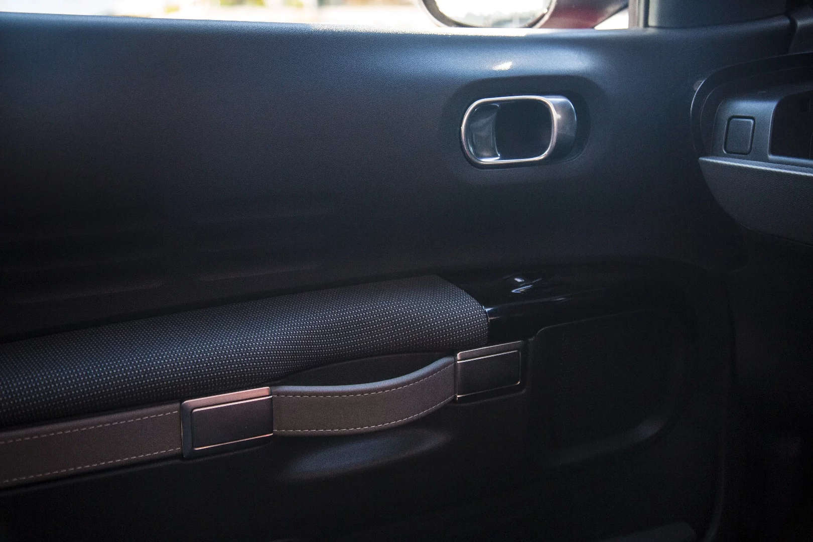 The door grab handles are leather straps