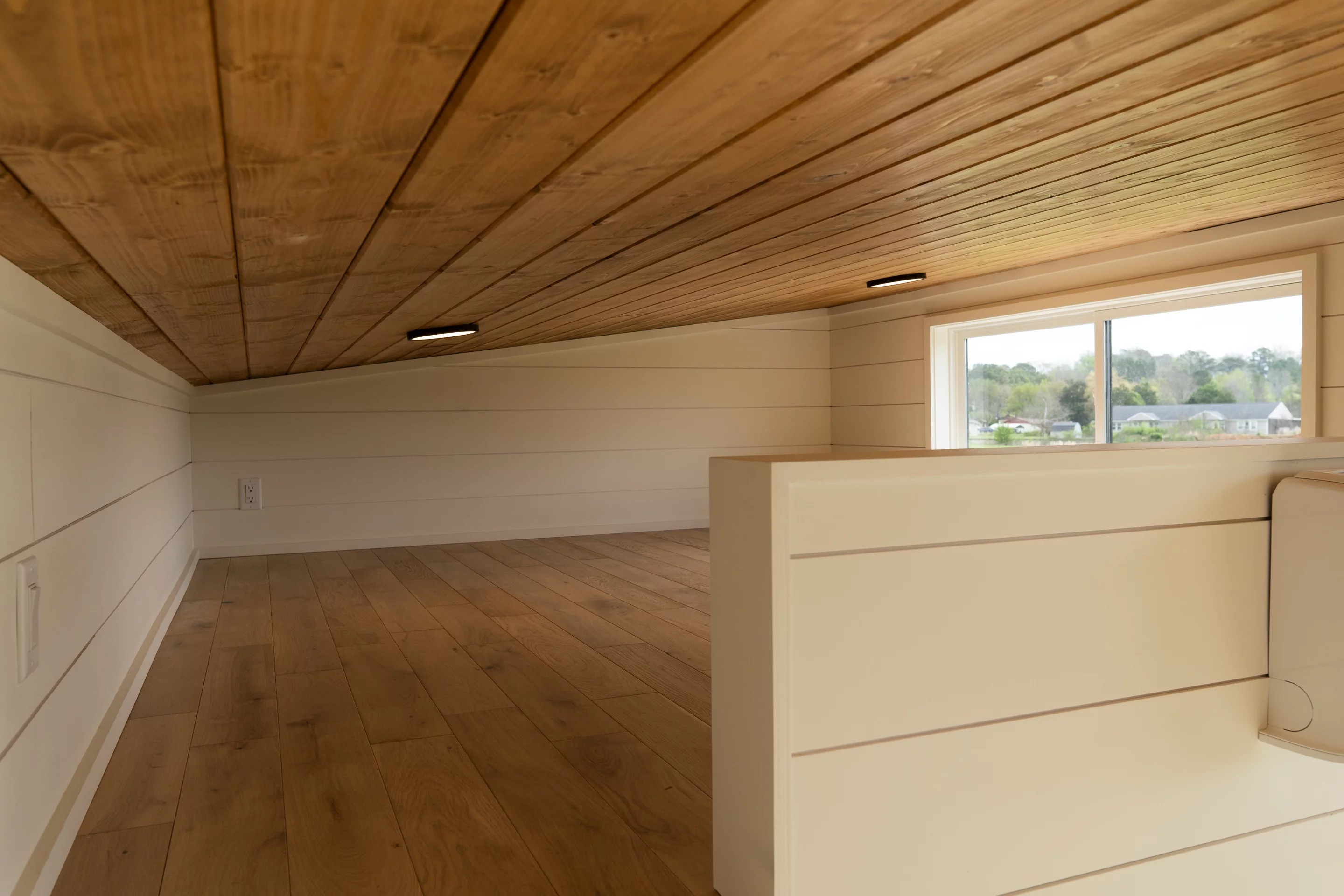 The Rutledge's loft bedroom has a low ceiling and space for a double bed