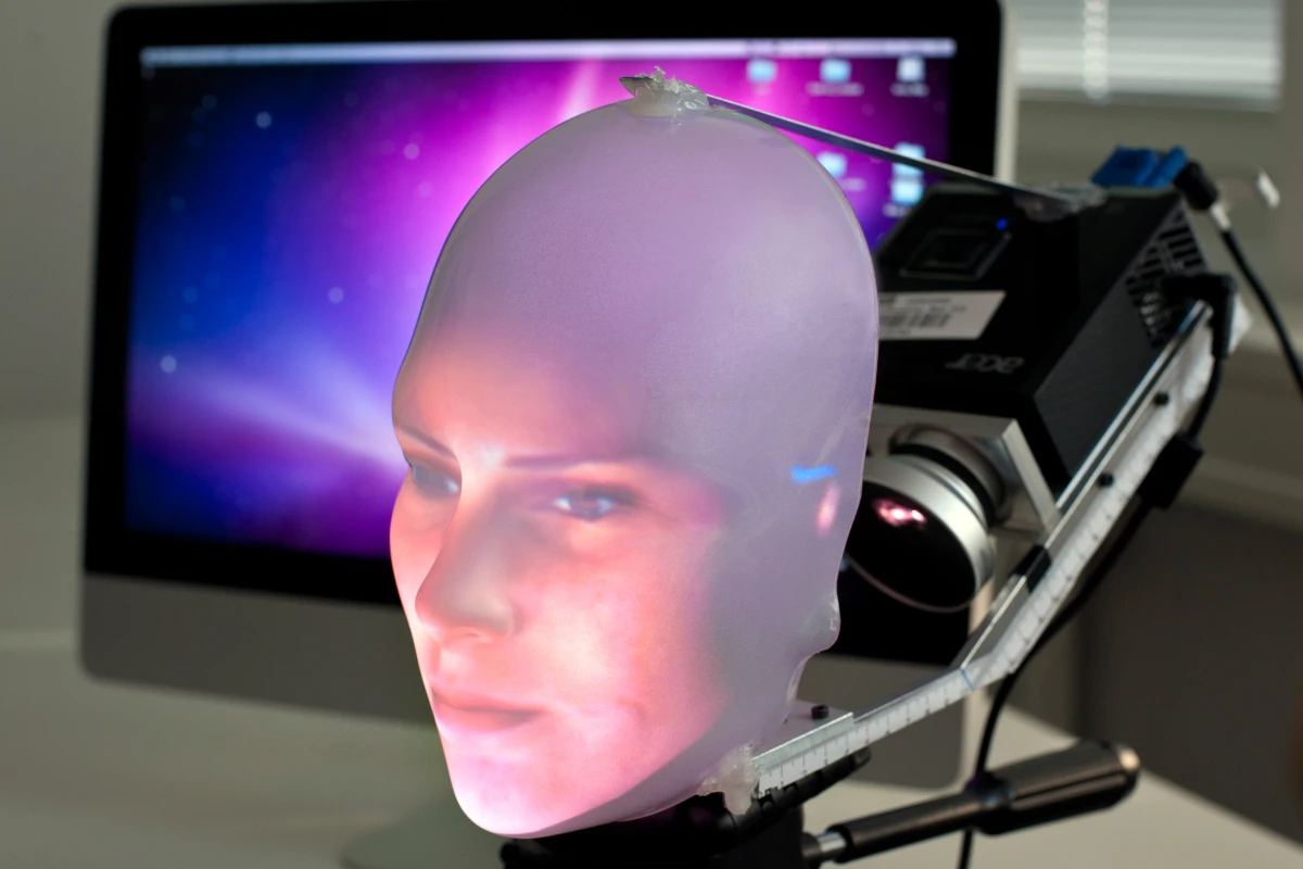 Mask-bot uses a small projector to beam the image of a face onto a transparent plastic mask