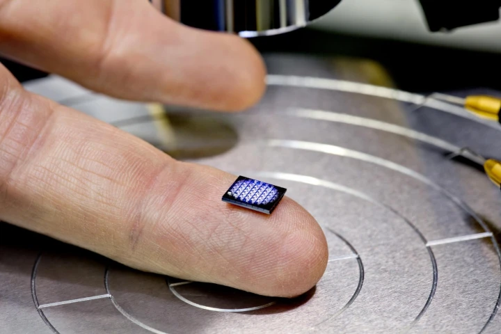 Among IBM's annual 5 in 5 list is the world's smallest computer, smaller than a grain of salt – seen here as the tiny white dot on the lefthand corner of the chip