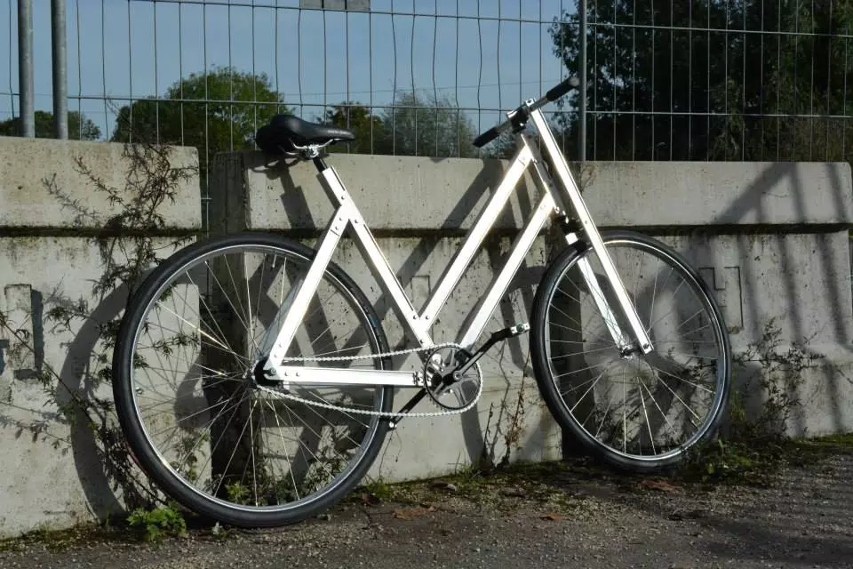 The Reframed bike's frame is made from extruded aluminum, and is bolted together by the buyer