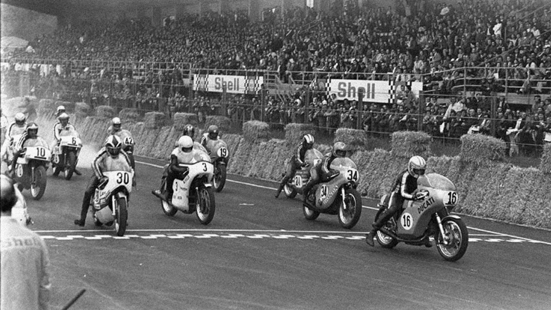 The race which began the Ducati V-twin legend. Giacomo Agostini was the logical favorite, having won almost every race he'd started at world championship level on factory MV Agustas since 1966. In the previous six years, he'd won 12 world titles, and he was riding a 750 class bike based on the 750 MV Agusta road bike. The Triumph, BSA and John Player Norton factory F750 teams were all present, as well as Helmut Dahne on a factory BMW, with Moto-Guzzi, Laverda, Honda, and Kawasaki all represented.