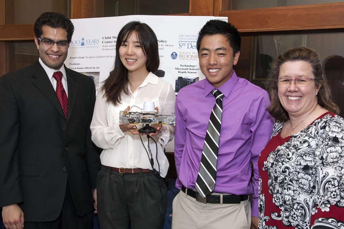 From left, students Anshul Mehra, Yejin Kim and Jeffrey Kamei, with their faculty sponsor Eileen McDonald (Photo: Norman Barker/homewoodphoto.jhu.edu)