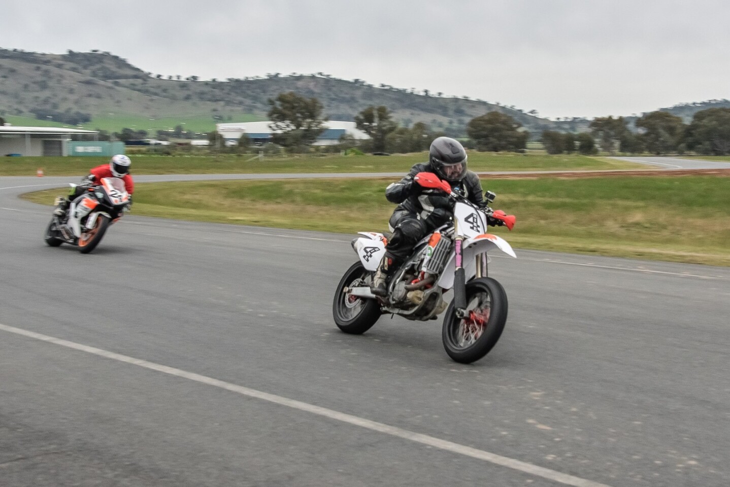 Exiting onto the main straight with coach Chas Hern close behind