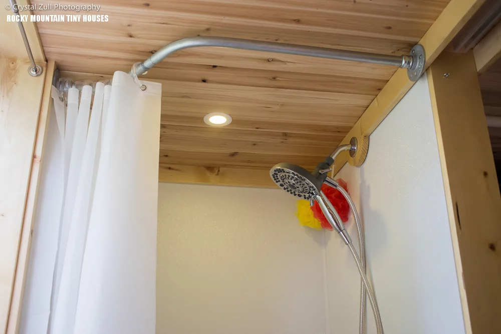 The bathroom sports a shower, sink and a composting toilet