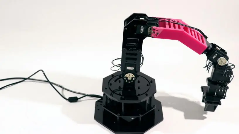 As part of its tests, the team 3D printed a new part (pink) that changed the arm's shape, and it was able to adjust its internal model of itself and get back to work