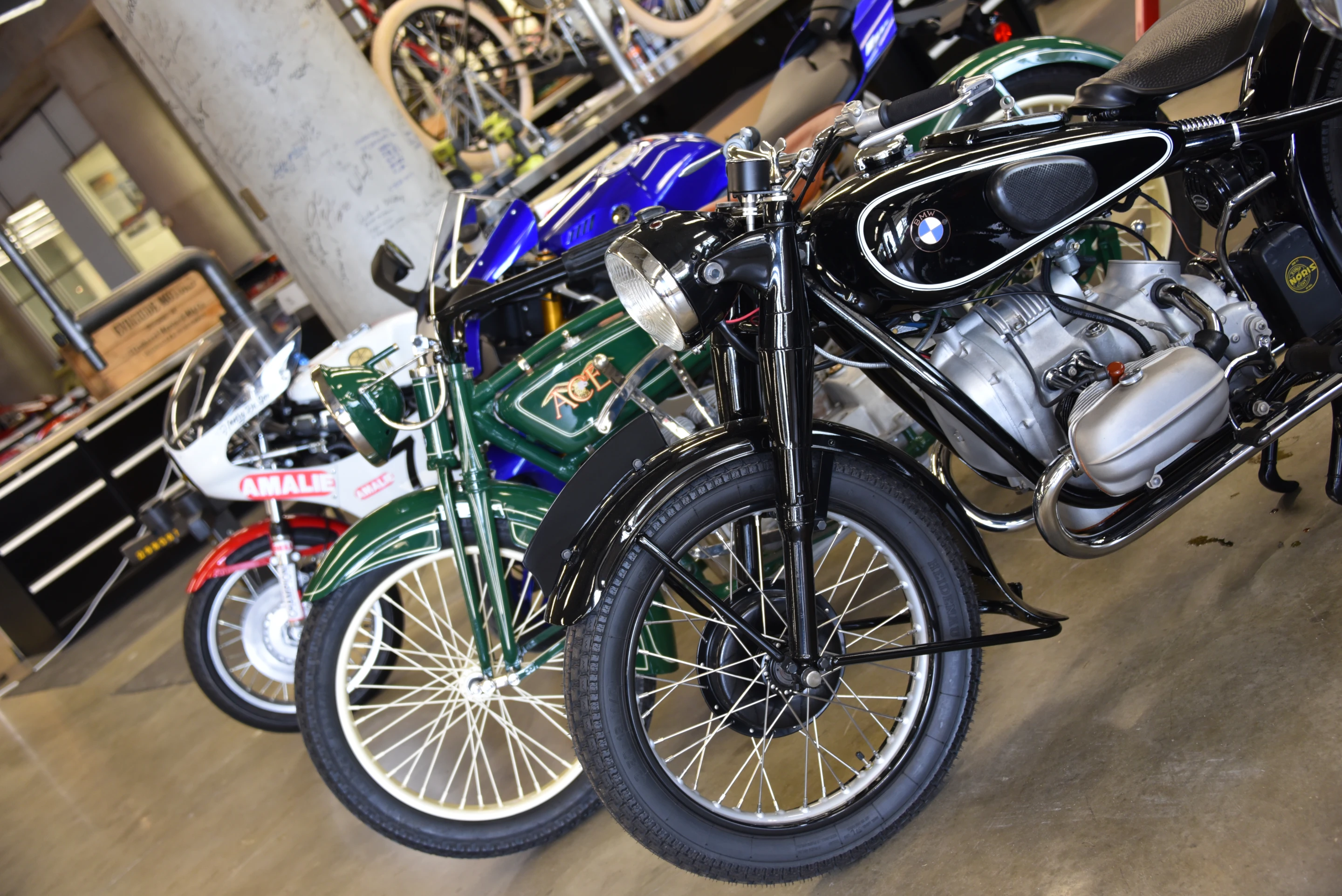 Vintage BMW, Ace and two Yamaha's lined up in the basement display area