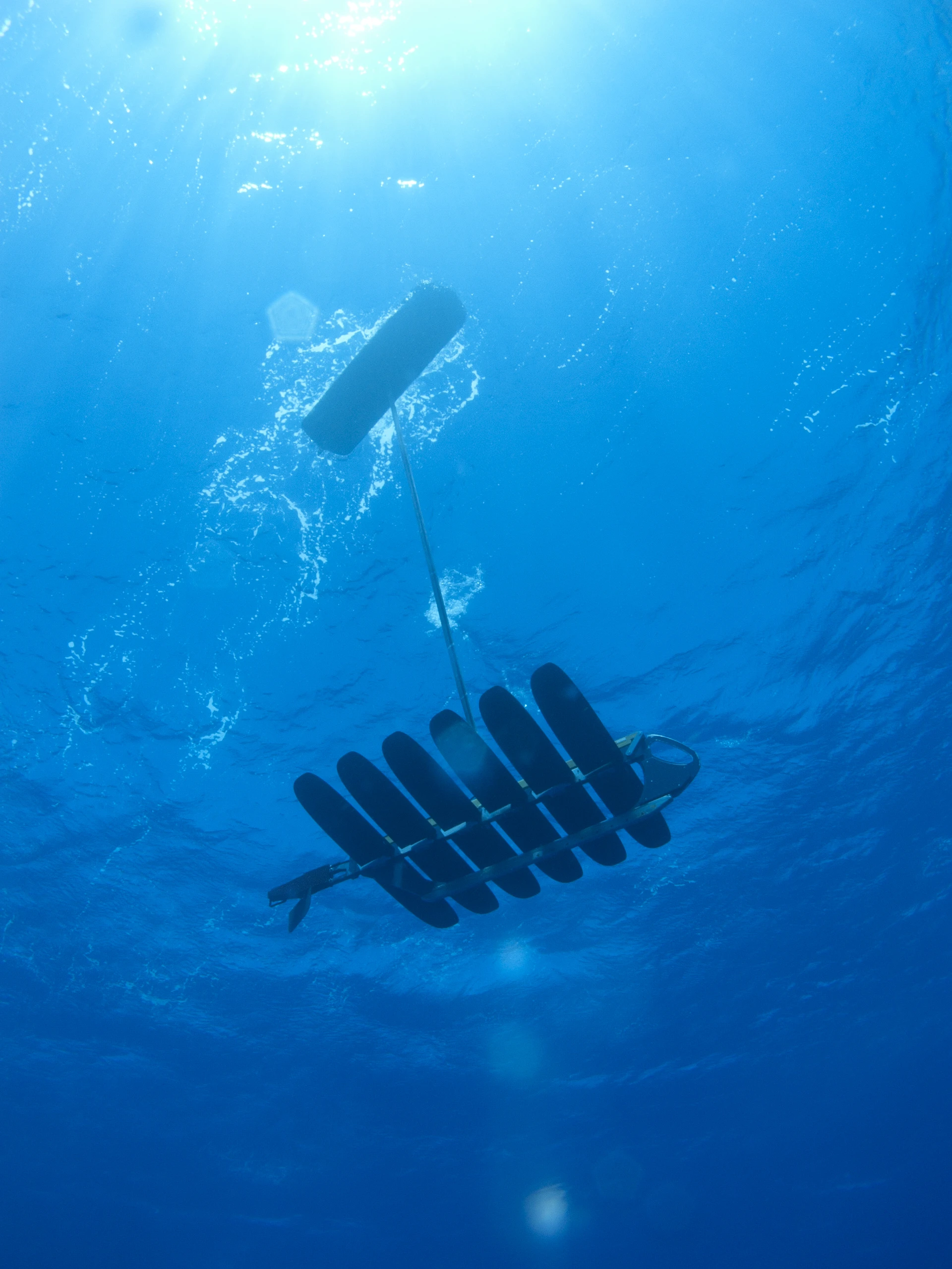 The winged component of one of the Wave Gliders, tethered to the floating section