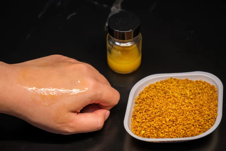 The camellia-pollen-based microgel applied to a test subject's hand (left), alongside its natural source