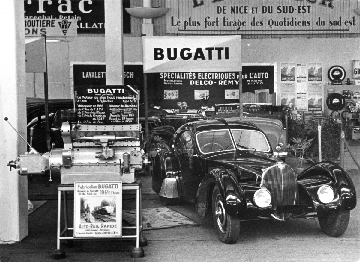 A Bugatti dealer promotes Bugatti's triumph in providing the engine that set a speed record for trains.