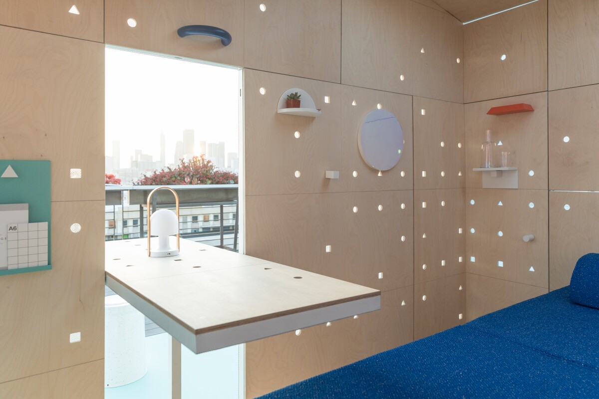 Space-saving mechanisms like folding dining tables and shelves and rotating panels feature throughout the Mini Living Urban Cabin in LA