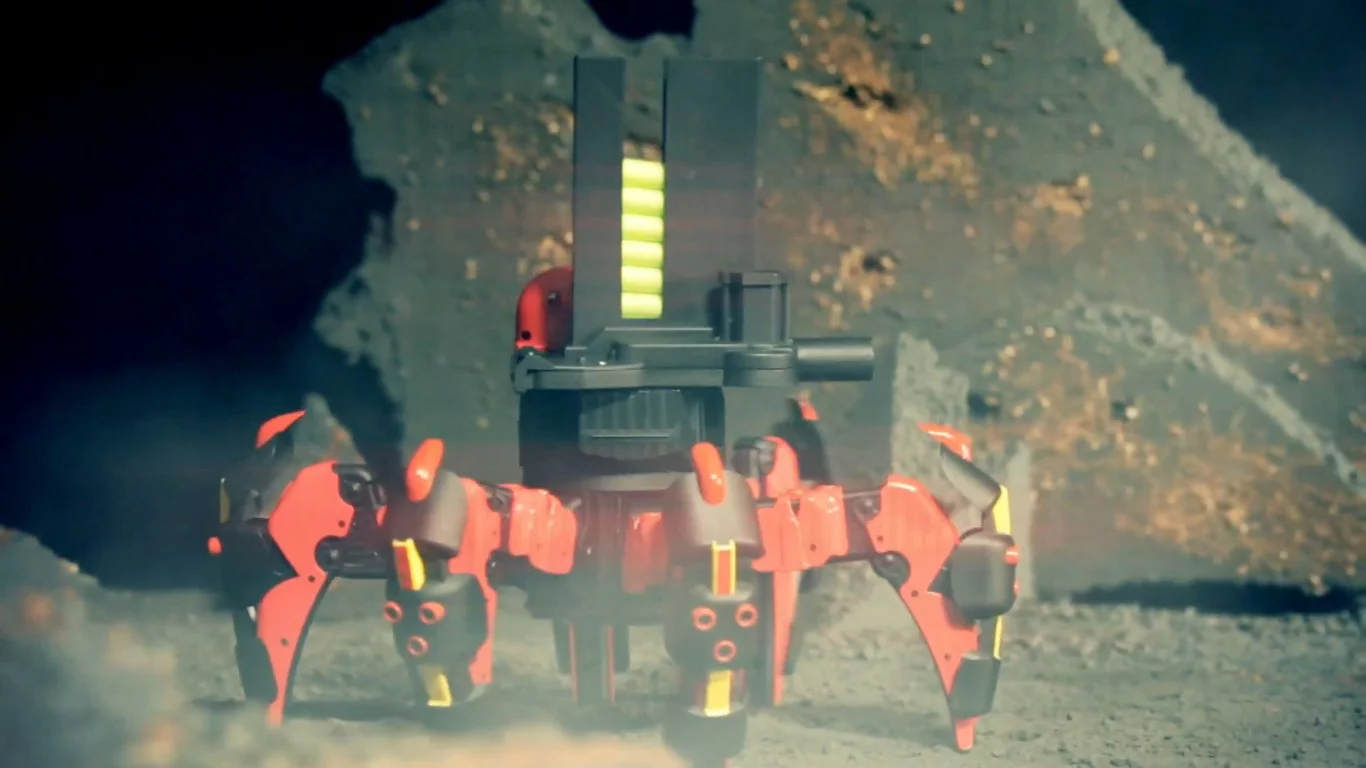 The toy robot's launchers can be aimed by remotely tilting it and shoots farther when the fire button is held down longer