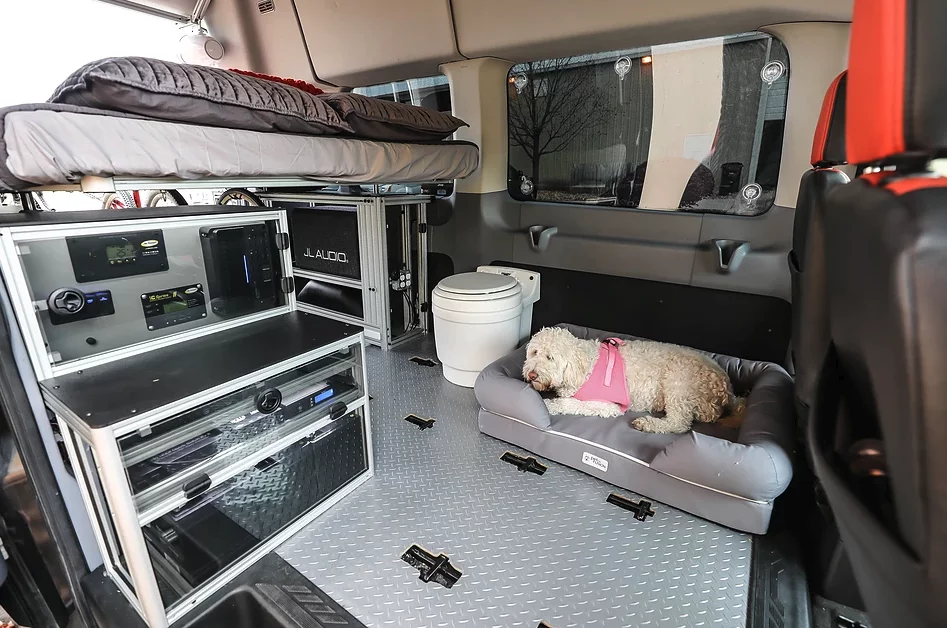 Take all the seats out and give the dog a place to stretch its legs and campers a place for relief