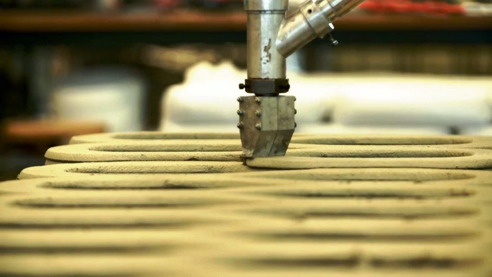 The 3D printer builds the structures layer by layer, producing individual pieces standing 1 m (3.3 ft) tall