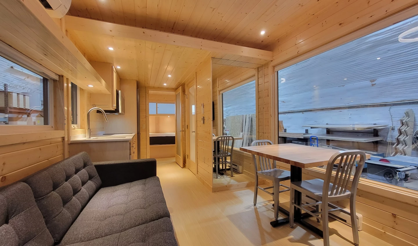 The eVista King's main living area includes a sofa and a dining/work table with seating for two