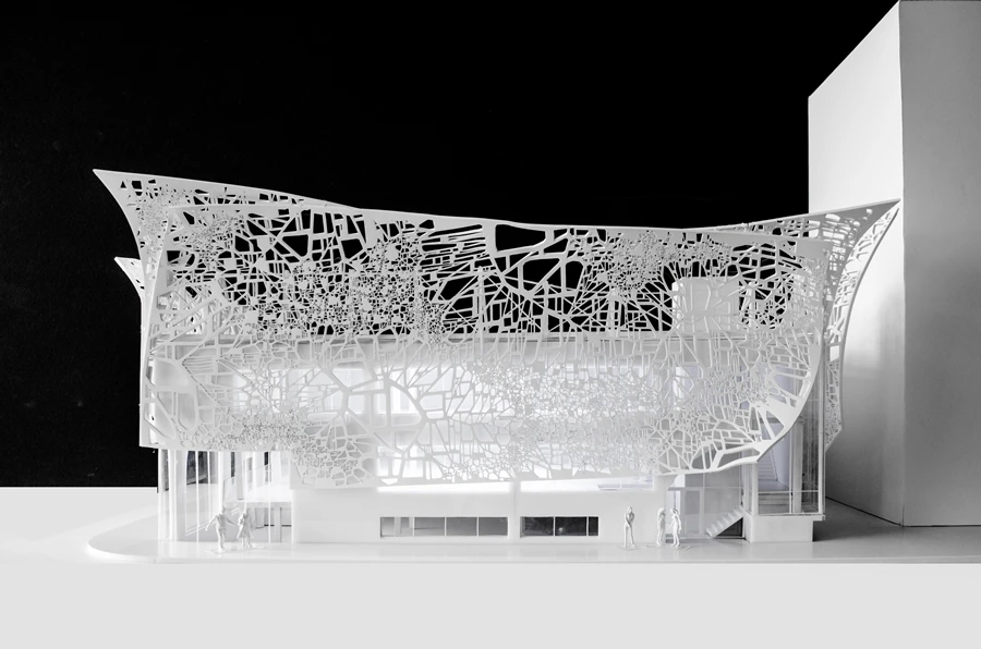 The pattern is applied to the façade by way of water-jet cutting