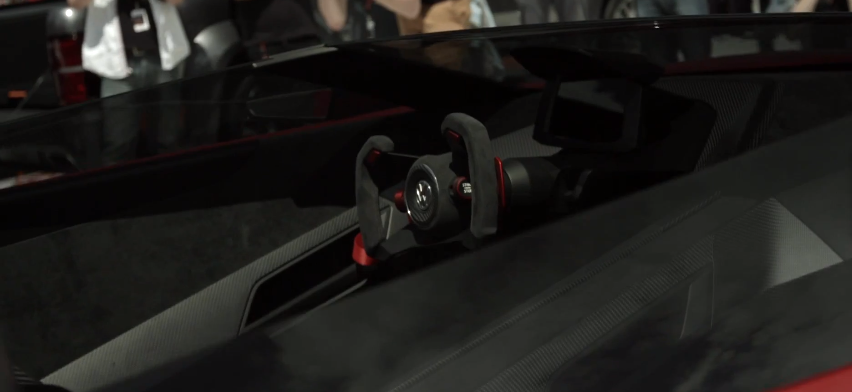 The driver is seated in a highly race-influenced cockpit