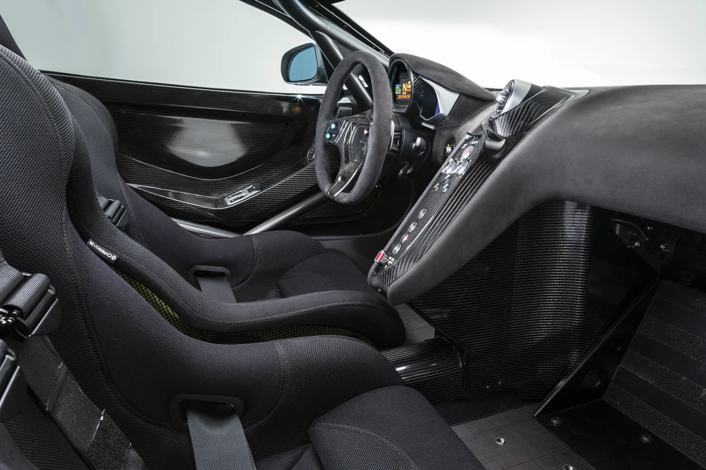 To enhance safety an FIA approved rollcage and carbon fiber HANS-approved racing seats, featuring six-point racing harness for the driver have been built into the snug new cockpit