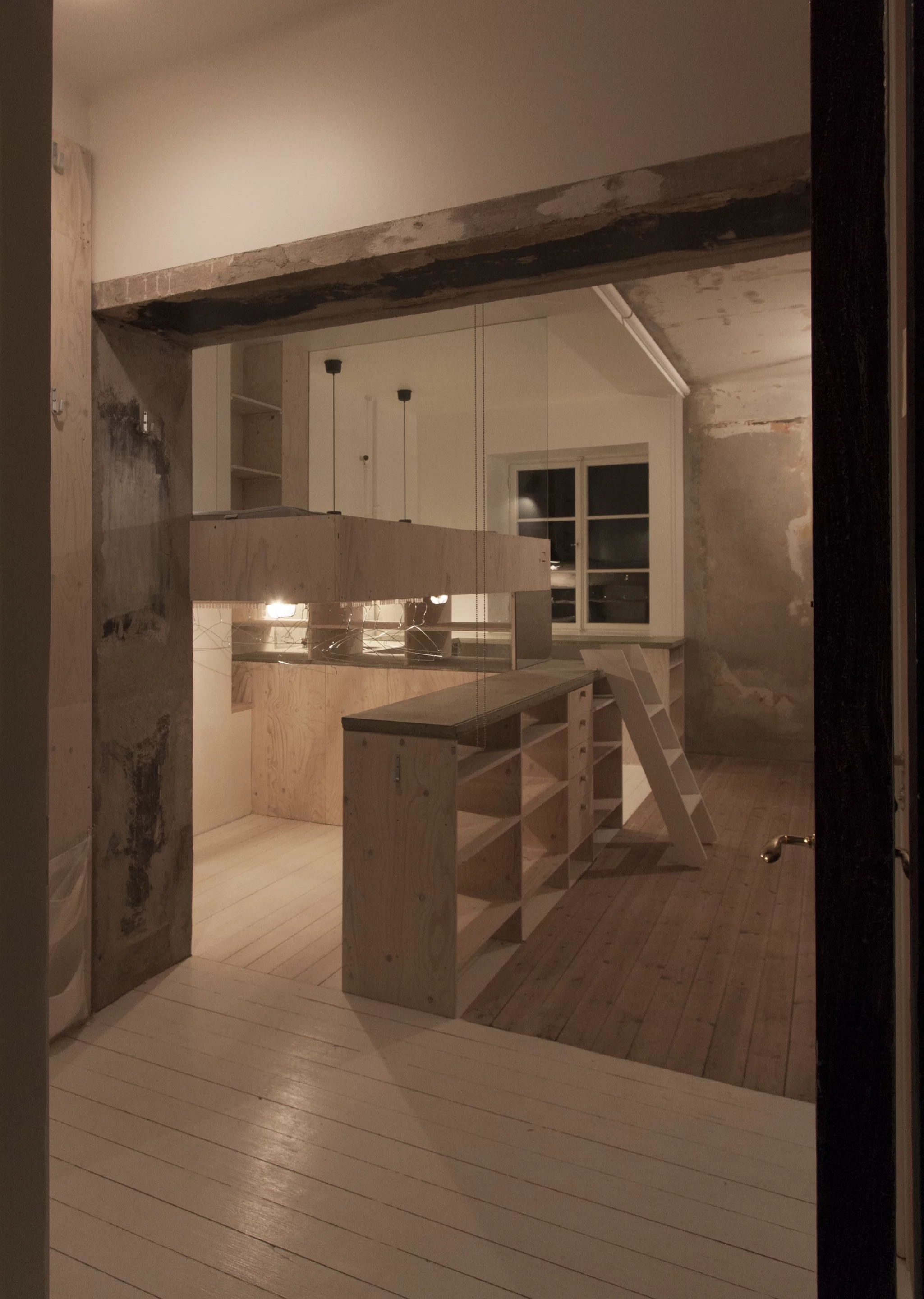 Using pine-plywood Matz based the design of the kitchen and bed area on an IKEA unit