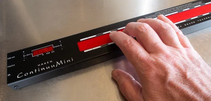 The ContinuuMini's red playing surface can translate movement from one or two fingers into expressive sounds
