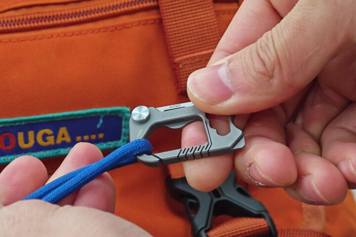 The Urbanix multitool in carabiner-clipping action