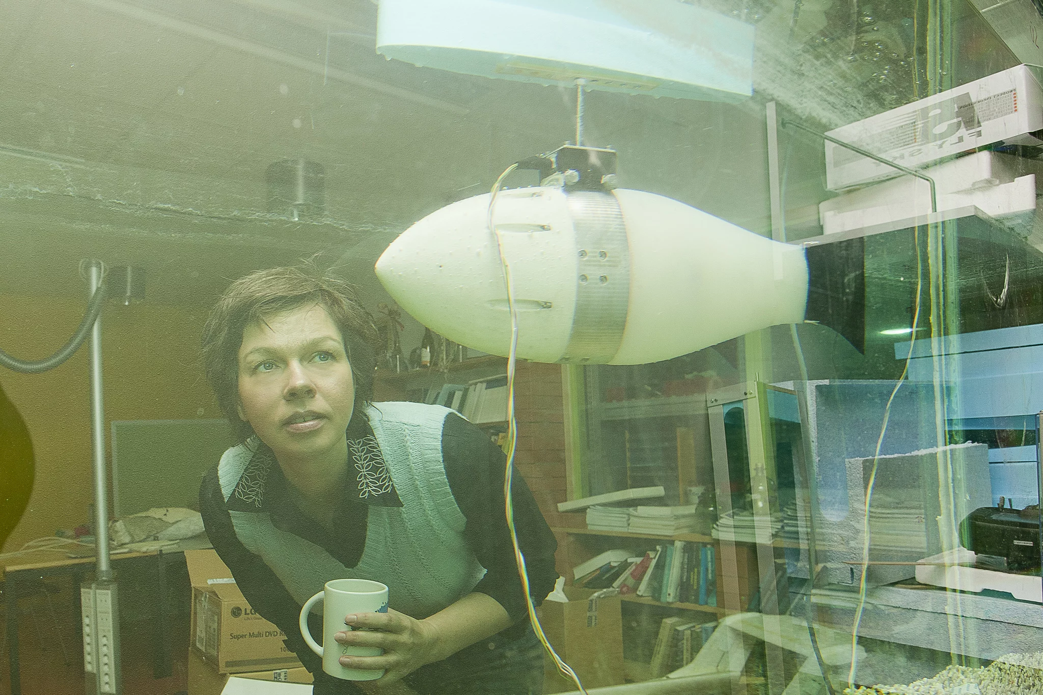 Tallinn University's Prof. Maarja Kruusmaa inspects one of the FILOSE robotic fish