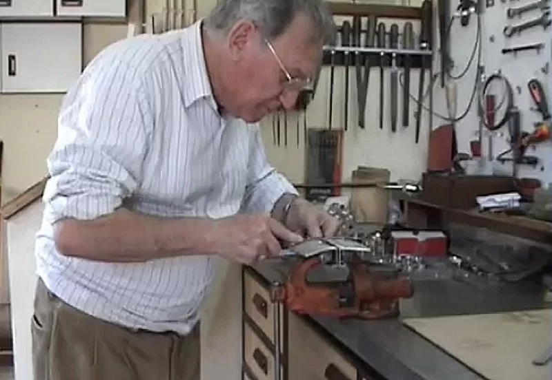 Patelo works on parts for his miniature V12 engine