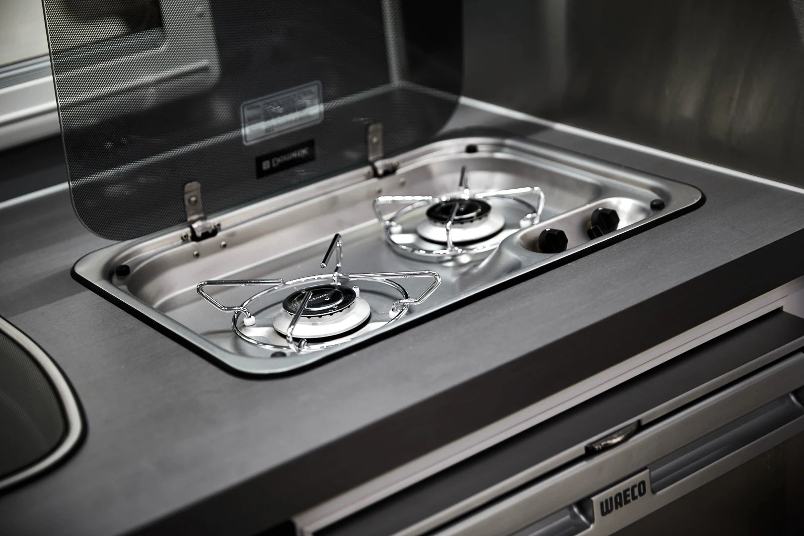 The kitchen includes a Dometic two-burner stove