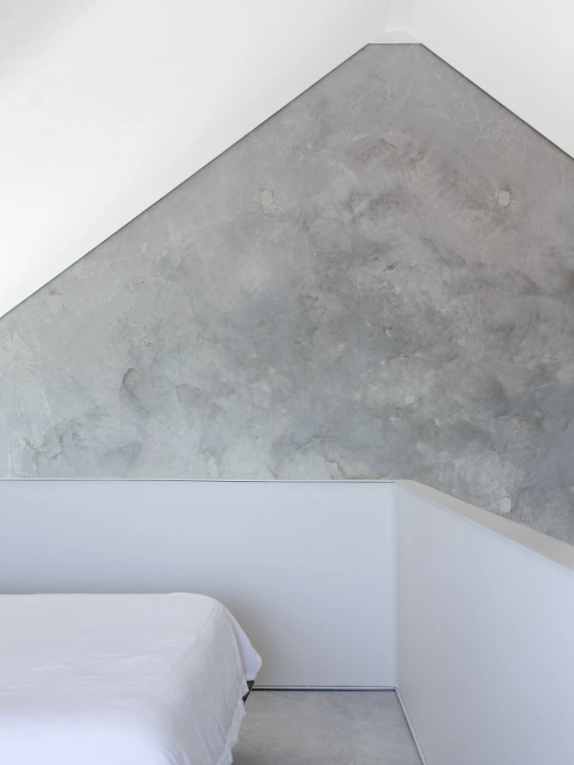 The elevated bedroom is kept open to allow light in