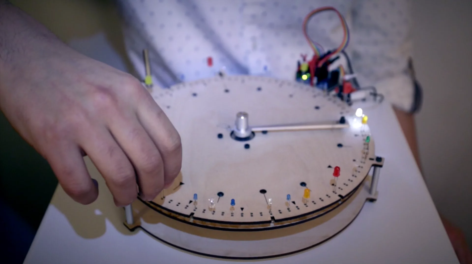 When the BlinkWheel's rotating arm comes into contact with an LED's anode, the light activates and a sound is triggered