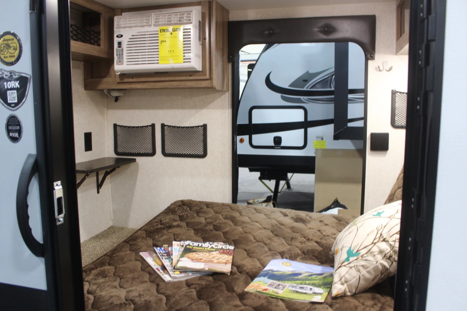 Not enough space to stand, but the Jayco Hummingbird still finds room for an air conditioner, microwave and TV