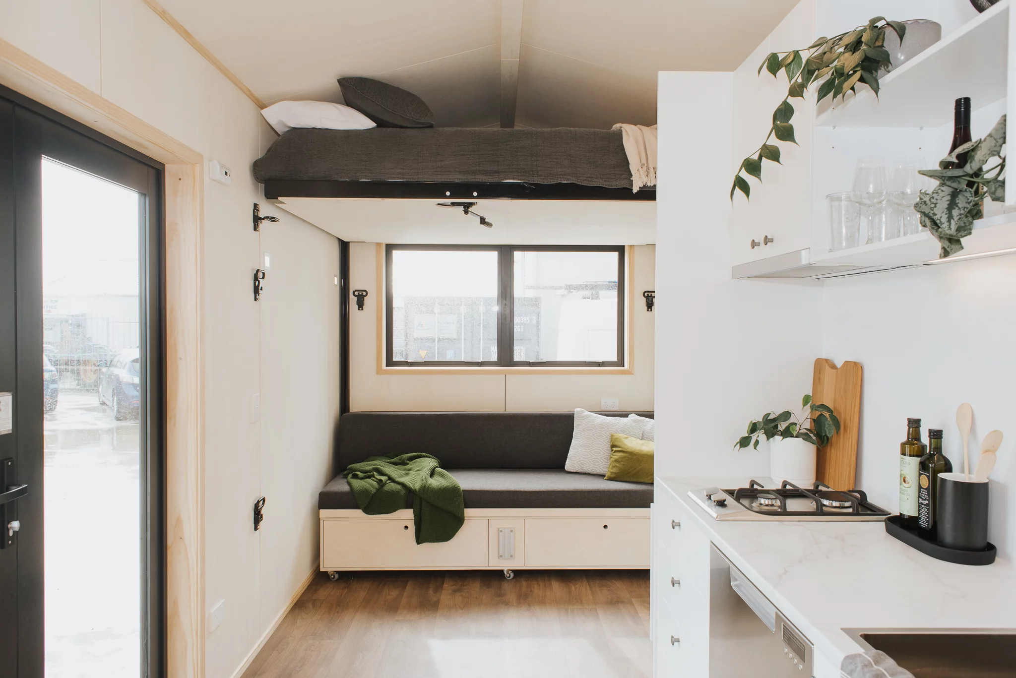 The Te Whare Nukunuku Tiny House's elevating bed is stowed away near the ceiling when not in use