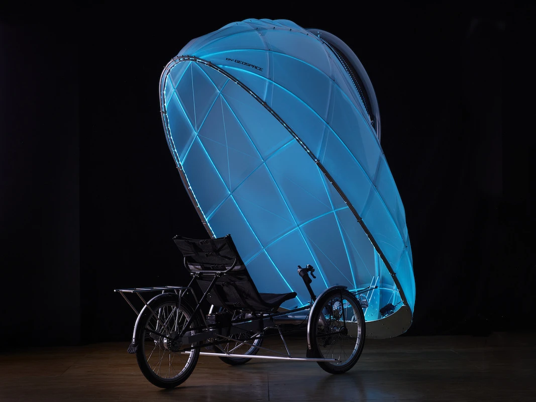 The shell tilts forward so a person can sit down and remain shielded from the cold, rain, or snow