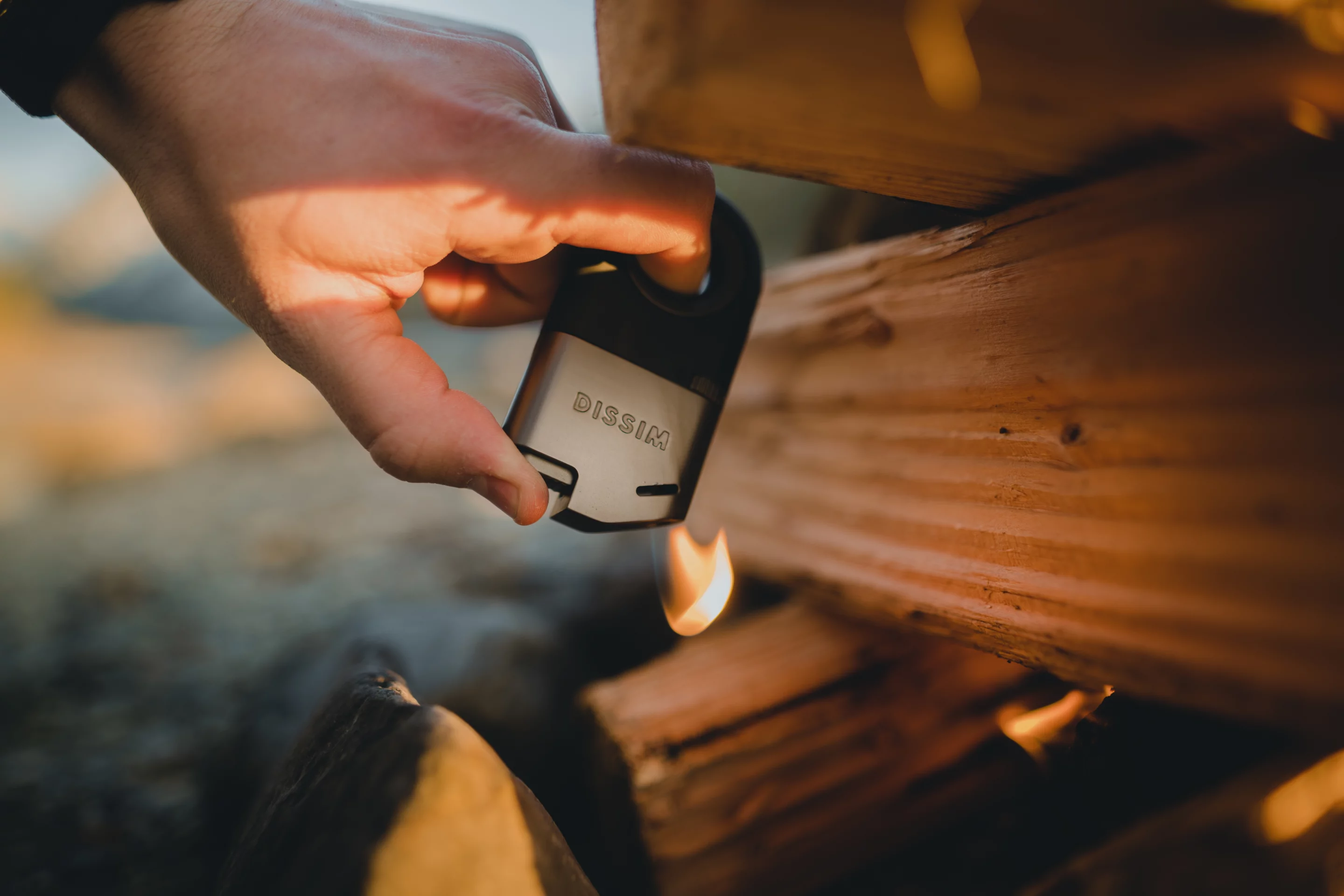 Lighting a tinder/kindling/fuel stack is a situation in which a small disposable lighter is almost guaranteed to burn your thumb; the Dissim lighter makes it less precarious
