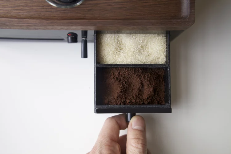 The Barisiuer features a drawer compartment to store ground coffee beans and sugar and a tube for a shot or two of milk