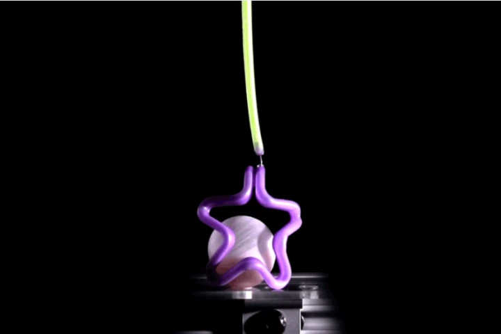 A star-shaped "hand" created using the bubble casting technique is capable of gently grasping a blueberry – or in this case a small sphere