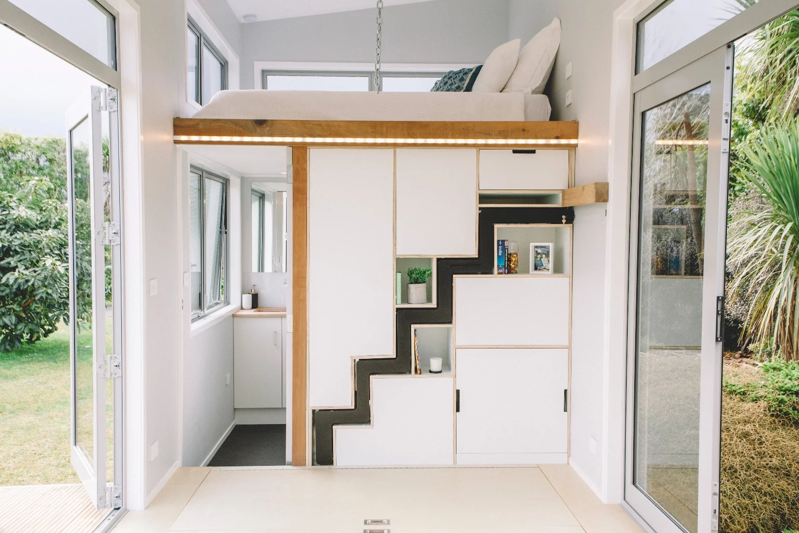 The Millennial Tiny House's retractable staircase and bathroom