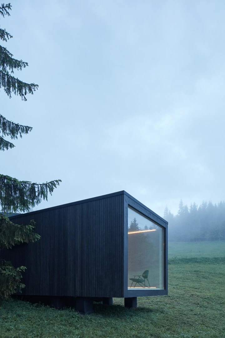 The Into the Wild cabin by Ark Shelter features a large glazed window to invite nature inside