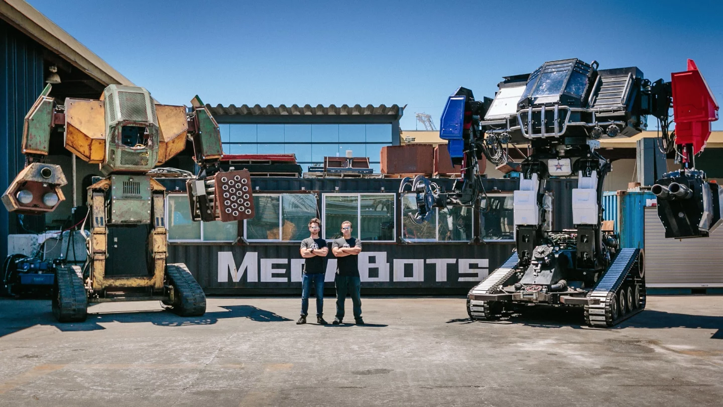 MegaBots co-founders Matt Oehrlein and Gui Cavalcanti with the Mk.II and Mk. III robots