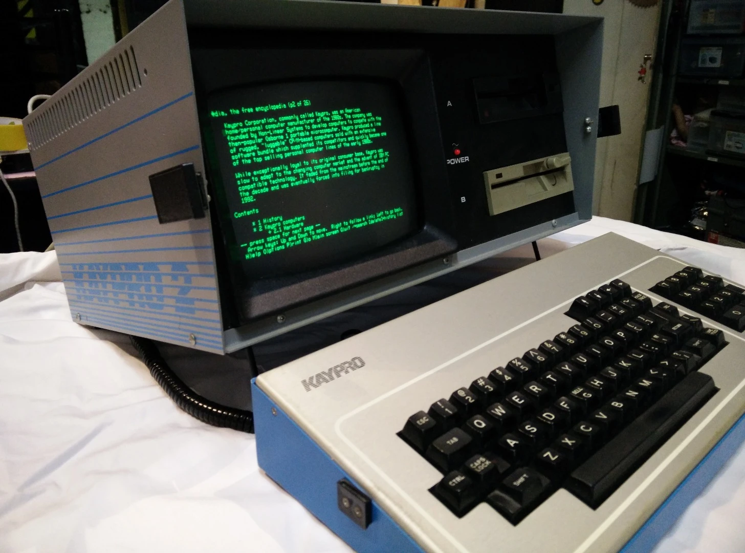The specs of the Kaypro II (1982) were virtually identical to the Osborne, but the Kaypro had a 2.5 MHz CPU, an aluminum case, and a 9" display