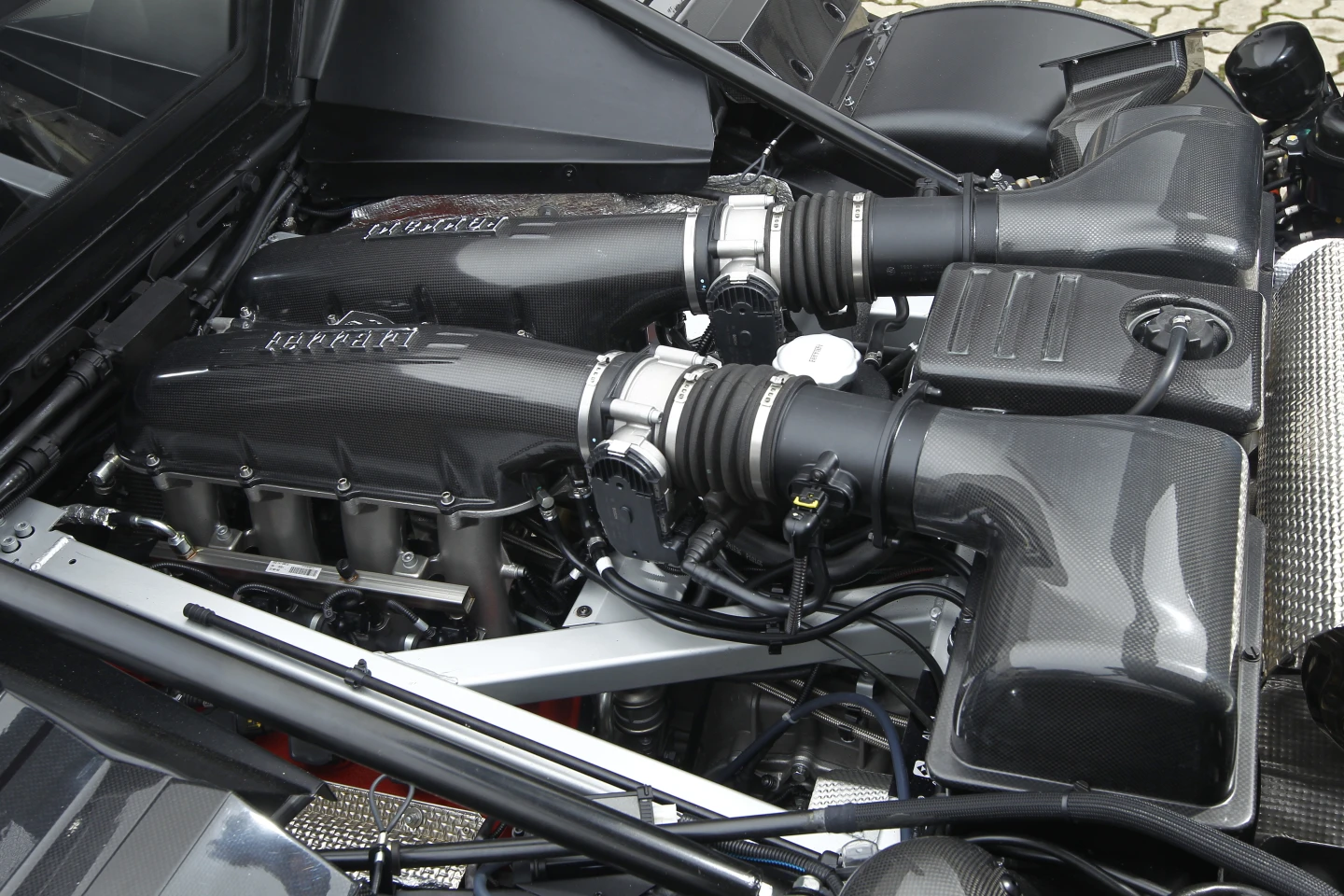 The 4.3-liter naturally-aspirated V8 from the Ferrari 430 Scuderia gets a performance boost to 540-hp (397 kW) and 383 lb-ft (519 Nm) of torque thanks to a titanium exhaust system and retuned ECU