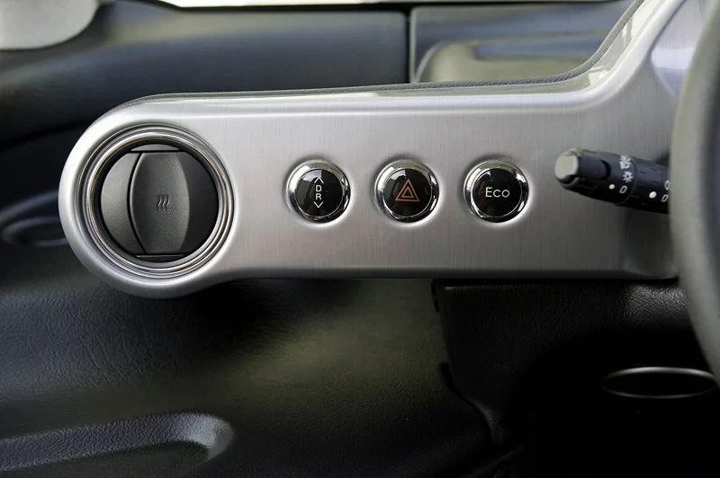 One of the two aluminum wings on either side of the steering wheel