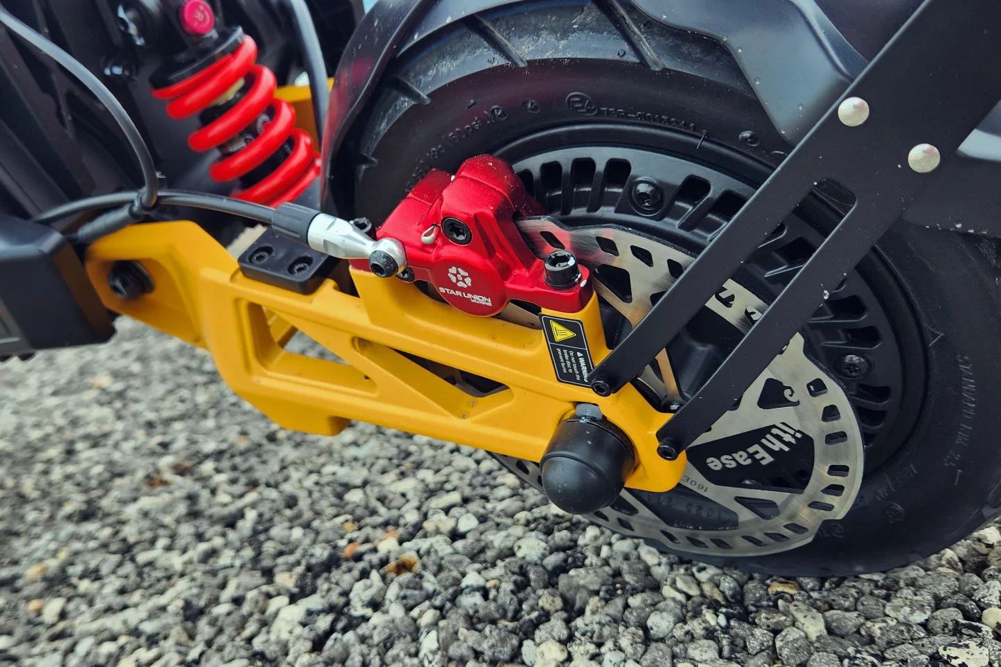 A better side view of the rear wheel. Because the rotors are so large, you do have to be thoughtful of them when pushing the scooter around tight corners and leaning it over too much ... you might deck out a rotor. The front is the same.