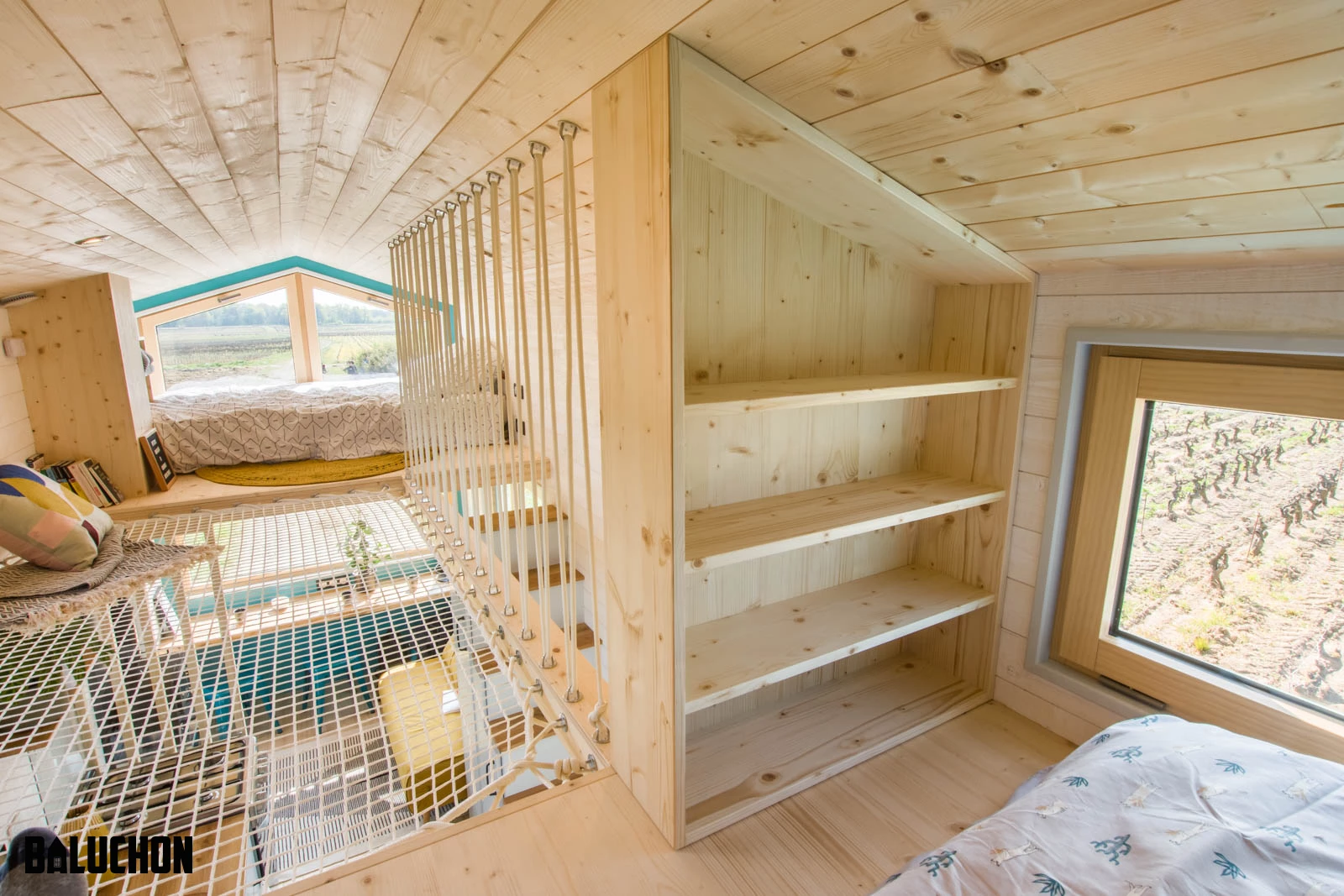 Tiny House Sïana's secondary bedroom includes a bed and some shelving
