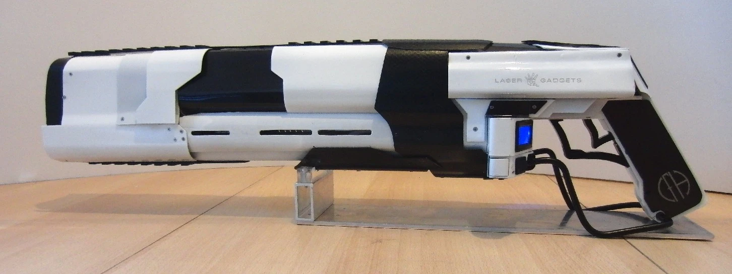 The mostly aluminum-bodied 12-lb (5.4-kg) rifle incorporates a 7-watt infrared burning laser, along with a 2-milliwatt red aiming laser