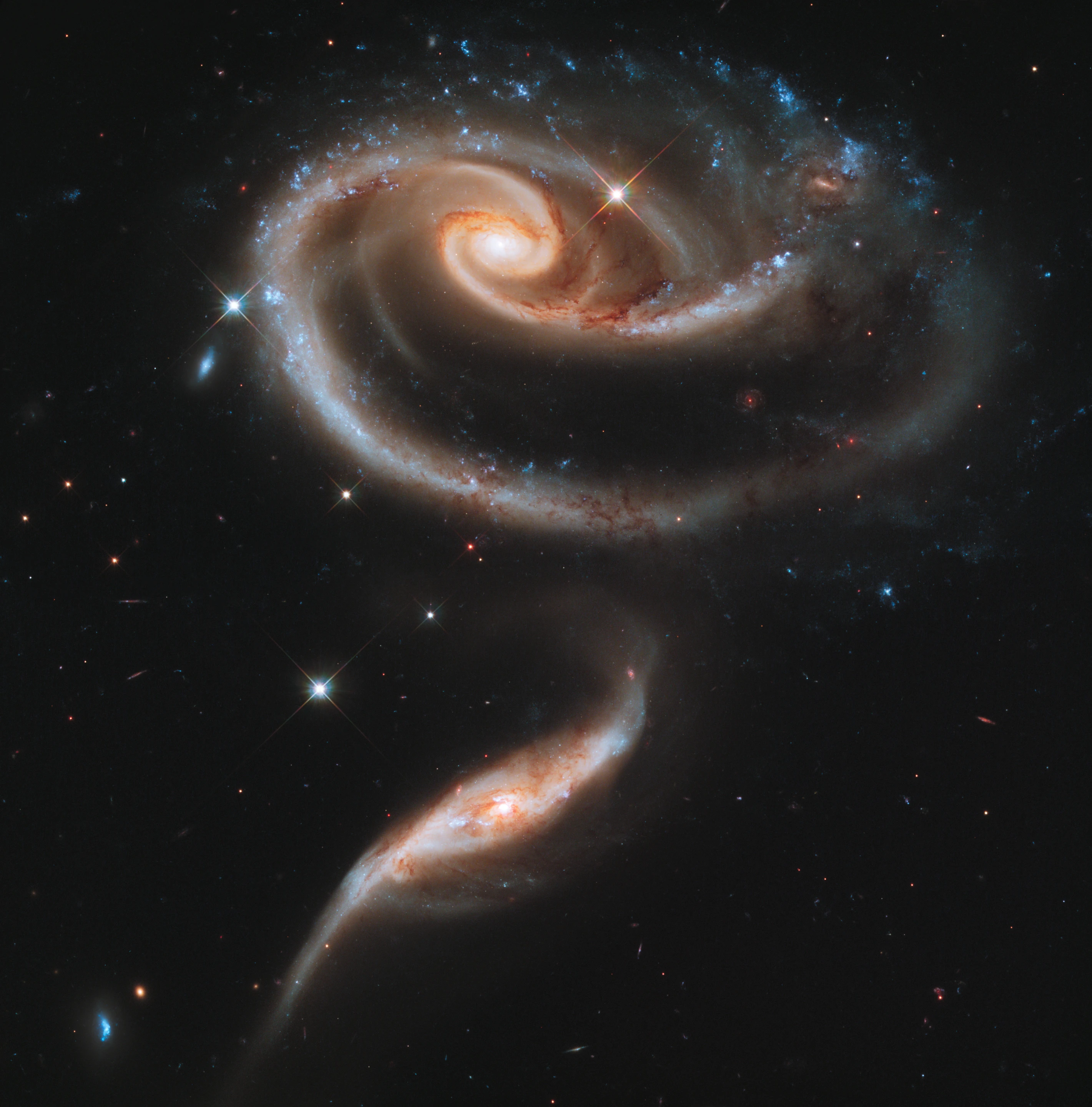 This image of a pair of interacting galaxies called Arp 273 was released to celebrate the 21st anniversary of the launch of the NASA/ESA Hubble Space Telescope